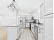 Bright kitchen with white cabinets, granite countertops, and stainless steel appliances, including a central island at 1305 Pagentry Dr, North Las Vegas, NV 89031