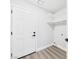 The laundry room features a white door and floating shelves for storage and organization at 1305 Pagentry Dr, North Las Vegas, NV 89031