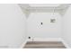 Laundry room with white walls and trim features overhead shelving ready for appliances at 1305 Pagentry Dr, North Las Vegas, NV 89031