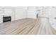 Spacious living room featuring new laminate floors and a stone fireplace at 1305 Pagentry Dr, North Las Vegas, NV 89031