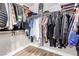 Spacious walk-in closet with hardwood floors and a variety of hanging clothes at 1360 Angel Falls St, Las Vegas, NV 89142