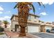 Charming two-story home in a residential neighborhood features a two-car garage and desert landscaping at 1360 Angel Falls St, Las Vegas, NV 89142