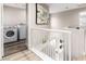 Upstairs hallway features a laundry room and modern decor at 1360 Angel Falls St, Las Vegas, NV 89142