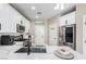 Modern kitchen with white cabinets, stainless steel appliances, pantry, and ample counter space at 1360 Angel Falls St, Las Vegas, NV 89142