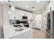 Bright kitchen boasts white cabinetry, stainless steel appliances, and a stunning white countertop island at 1360 Angel Falls St, Las Vegas, NV 89142