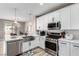 Well-lit kitchen featuring stainless steel appliances, sleek countertops, and an open layout at 1360 Angel Falls St, Las Vegas, NV 89142