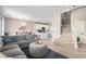Open concept living room features wood floors, neutral paint, access to kitchen and stairway at 1360 Angel Falls St, Las Vegas, NV 89142