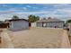 Wide view of the backyard featuring a storage shed and sandy area, with mature trees in the background at 1414 S 13Th St, Las Vegas, NV 89104