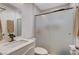 Bathroom showcasing a modern vanity, frosted glass shower door, and neutral tile, creating a clean aesthetic at 1414 S 13Th St, Las Vegas, NV 89104