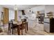 Dining area with a dark wood table and view of a bright kitchen with modern appliances and island at 1414 S 13Th St, Las Vegas, NV 89104
