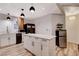 Bright kitchen featuring white cabinetry, stainless steel appliances, and a large island with wood-look flooring at 1414 S 13Th St, Las Vegas, NV 89104