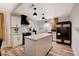 Bright kitchen featuring white cabinets, a large island, modern appliances, and stylish pendant lighting at 1414 S 13Th St, Las Vegas, NV 89104