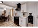 Modern kitchen with white cabinetry, black appliances, and a dining area in an open-concept layout at 1414 S 13Th St, Las Vegas, NV 89104