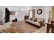 Spacious living room with a sofa, television, hardwood floors and natural light. Dining table in background at 1414 S 13Th St, Las Vegas, NV 89104