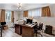 A charming home office is furnished with an expansive wood desk, modern lighting and wood laminate flooring at 1414 S 13Th St, Las Vegas, NV 89104