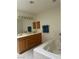 Bathroom featuring a double sink vanity, bathtub with tile surround, and modern fixtures at 1461 E Elderberry St, Pahrump, NV 89048