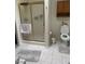 Bathroom featuring a tiled floor, glass shower enclosure, built-in shelf, and toilet at 1461 E Elderberry St, Pahrump, NV 89048