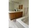 Bathroom with double sink vanity, tile floors, soaking tub and large mirror at 1461 E Elderberry St, Pahrump, NV 89048