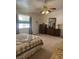 Traditional bedroom showcasing a decorative bedspread, dresser with mirror, and a charming ceiling fan fixture at 1461 E Elderberry St, Pahrump, NV 89048