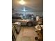 Spacious garage with a car, storage shelves, and other various items for organization and functionality at 1461 E Elderberry St, Pahrump, NV 89048