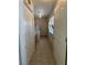 Bright hallway leading to the laundry area, featuring tile floors and ample closet space at 1461 E Elderberry St, Pahrump, NV 89048