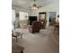 Comfortable living room with neutral carpeting, ceiling fan, and lots of natural light at 1461 E Elderberry St, Pahrump, NV 89048