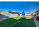 Backyard features artificial turf, patio area, picnic table and barbecue at 1631 Ottawa Dr, Las Vegas, NV 89169