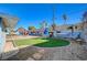 Lush backyard with artificial lawn, outdoor seating, and a hammock at 1631 Ottawa Dr, Las Vegas, NV 89169