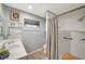 Bathroom with a white vanity, a window, and a shower featuring a curtain at 1631 Ottawa Dr, Las Vegas, NV 89169