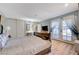 Bright bedroom featuring light wood floors, closet doors, and doors leading to the exterior at 1631 Ottawa Dr, Las Vegas, NV 89169