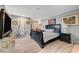 Spacious bedroom featuring a dark wood bed frame, stylish decor, and light wood flooring at 1631 Ottawa Dr, Las Vegas, NV 89169