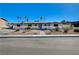 Charming single-story home with a blue door and desert landscaping at 1631 Ottawa Dr, Las Vegas, NV 89169