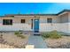 Charming single-story home with a cheerful blue door and desert landscaping at 1631 Ottawa Dr, Las Vegas, NV 89169