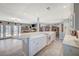 Open-concept kitchen with white cabinets, marble countertops, and modern appliances at 1631 Ottawa Dr, Las Vegas, NV 89169
