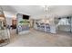 Open-concept living room with a fireplace, tile flooring, breakfast bar and views of the kitchen at 1631 Ottawa Dr, Las Vegas, NV 89169
