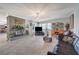 Spacious living room with a stone fireplace, tile flooring, and a comfortable leather sofa at 1631 Ottawa Dr, Las Vegas, NV 89169
