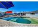 Gorgeous pool with lounge area, fire pit, mature trees, and covered outdoor living spaces at 1631 Ottawa Dr, Las Vegas, NV 89169