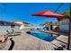 Beautiful backyard featuring a sparkling pool, shaded lounge area, and serene ambiance at 1631 Ottawa Dr, Las Vegas, NV 89169