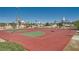Outdoor basketball court with vibrant red and green surface in the neighborhood, perfect for sports and recreation at 1641 Blue Cliffs Ave, Henderson, NV 89014