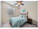 Cozy bedroom featuring a bed with decorative headboard, neutral walls, and a window with blinds for natural light at 1641 Blue Cliffs Ave, Henderson, NV 89014