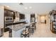 Open kitchen with granite countertops, stainless steel appliances, and breakfast bar at 1641 Blue Cliffs Ave, Henderson, NV 89014