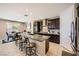 Modern kitchen featuring dark wood cabinets, stainless steel appliances, and granite countertops at 1641 Blue Cliffs Ave, Henderson, NV 89014