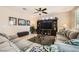 Comfortable living room with ample seating, tile flooring, ceiling fan and natural light at 1641 Blue Cliffs Ave, Henderson, NV 89014