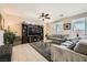 Spacious living room with tile flooring, ceiling fan, and large windows at 1641 Blue Cliffs Ave, Henderson, NV 89014
