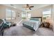 Bright main bedroom with large windows, ceiling fan, and neutral carpeting at 1641 Blue Cliffs Ave, Henderson, NV 89014