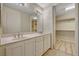 Bright bathroom featuring double sinks and a spacious walk-in closet for optimal storage and organization at 20 E Serene Ave # 401, Las Vegas, NV 89123