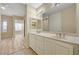 Bright bathroom features dual sinks with white cabinetry and a large mirror at 20 E Serene Ave # 401, Las Vegas, NV 89123