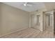 Bedroom featuring wood-style floors, a ceiling fan, and mirrored closet doors at 20 E Serene Ave # 401, Las Vegas, NV 89123