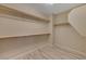Spacious walk-in closet with shelving units and wood-style flooring at 20 E Serene Ave # 401, Las Vegas, NV 89123