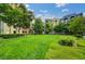 Well-maintained community lawn with manicured bushes and mature trees surrounding condo buildings at 20 E Serene Ave # 401, Las Vegas, NV 89123